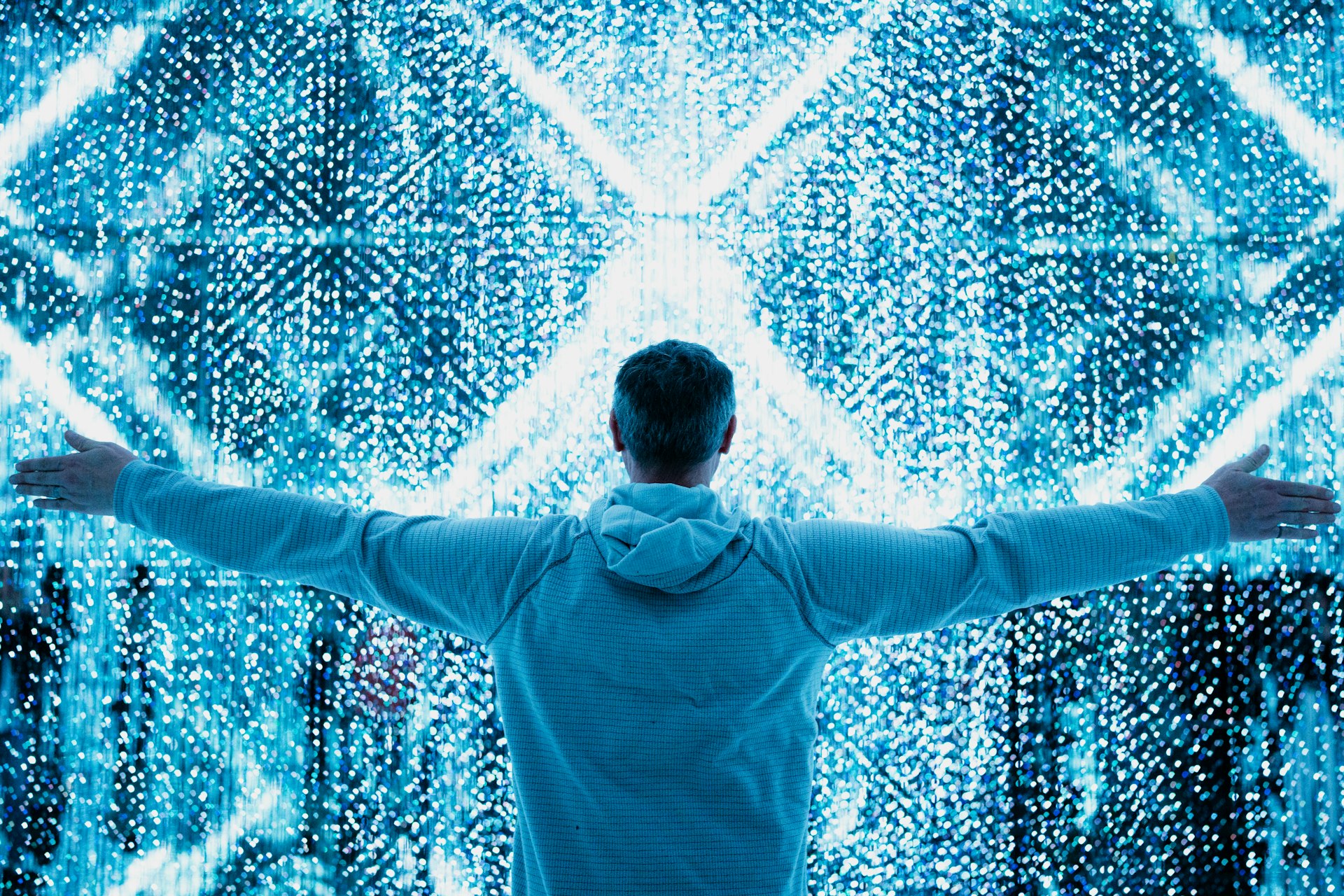 A man standing in front of a large display of numbers
